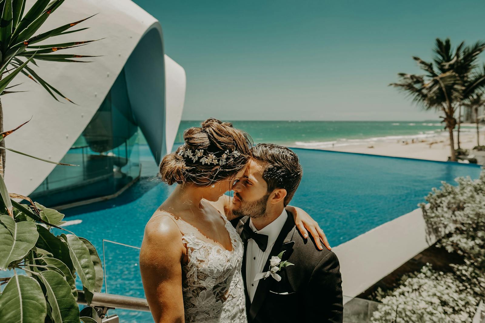 A couple embraces on their wedding day by the ocean in Puerto Rico, exuding love and elegance.